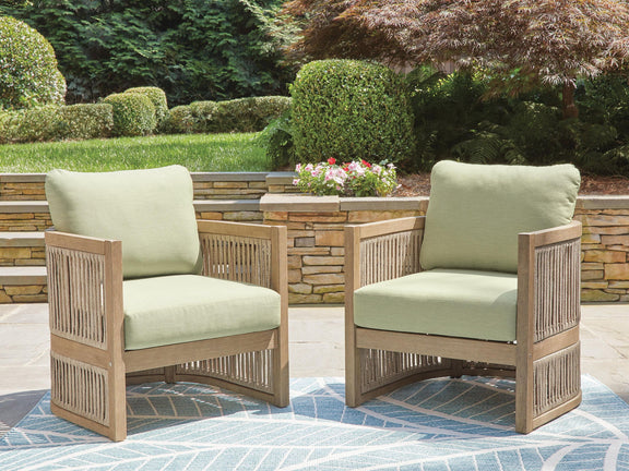 Set of 2 lounge chairs with green cushions, light wood frames for patio seating