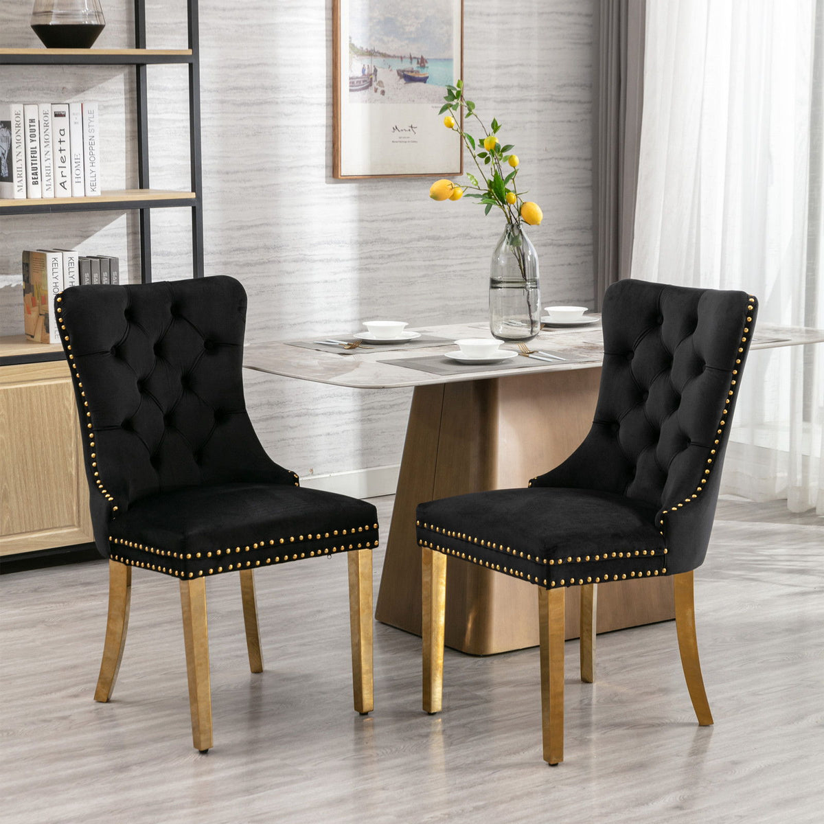 Black tufted dining chair with gold nailhead trim and padded seat-back