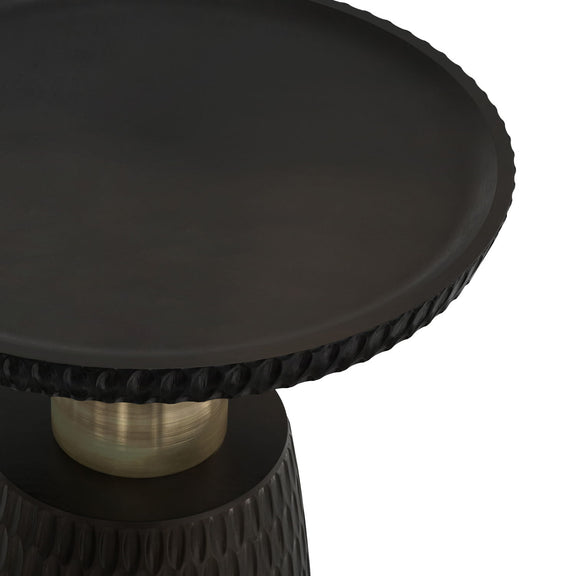 Close-up of the black round tabletop, textured rim, and gold-tone support column.