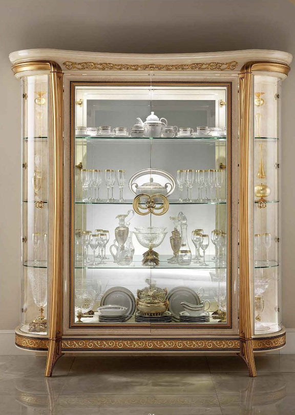 Beige and gold 4-door glass display cabinet with ornate trim and mirrored shelves