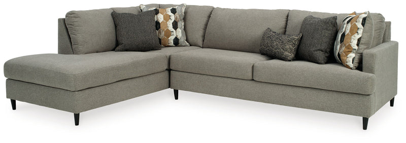 Gray chaise sectional sofa with dark accent pillow and patterned lumbar pillow.