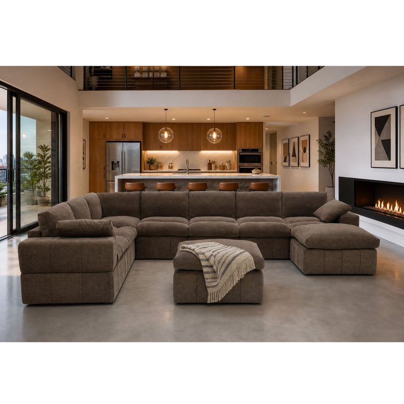 Dark brown sectional sofa with broad arms, chaise ends and a toss pillow