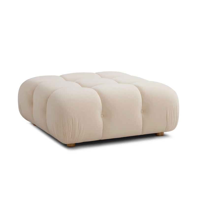 Beige modular ottoman with plush cushions, button-tufted panels, and short feet