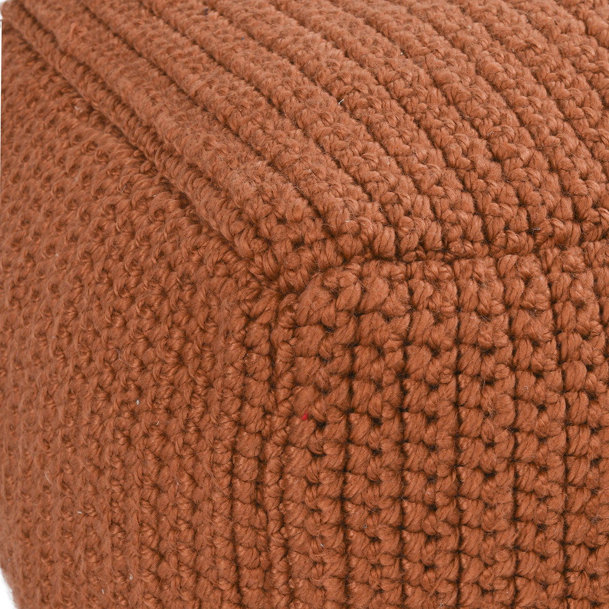 Terracotta knitted pouf fabric close-up with chunky ribbed crochet texture