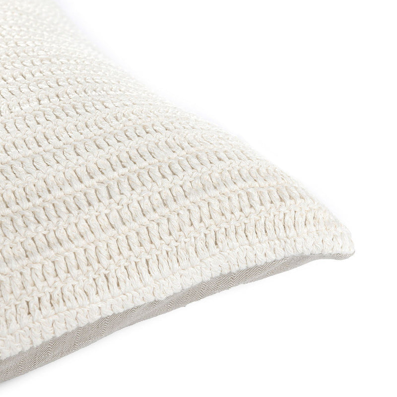 Close-up of white textured woven lumbar pillow fabric and seam edge