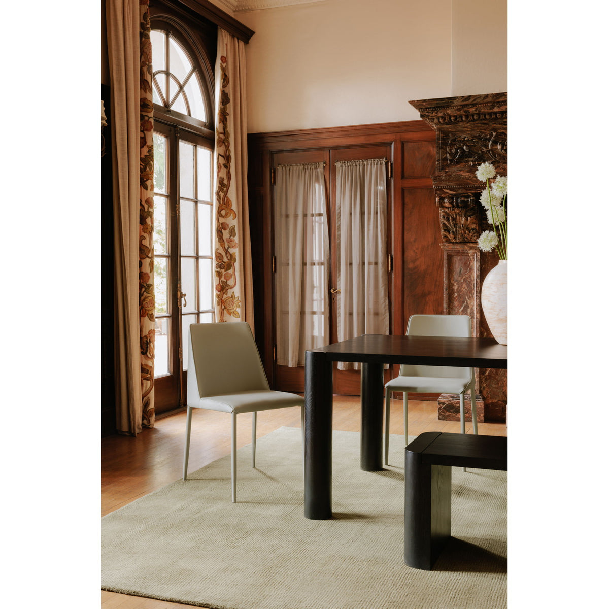 Black dining bench with thick rectangular frame and rounded corner legs