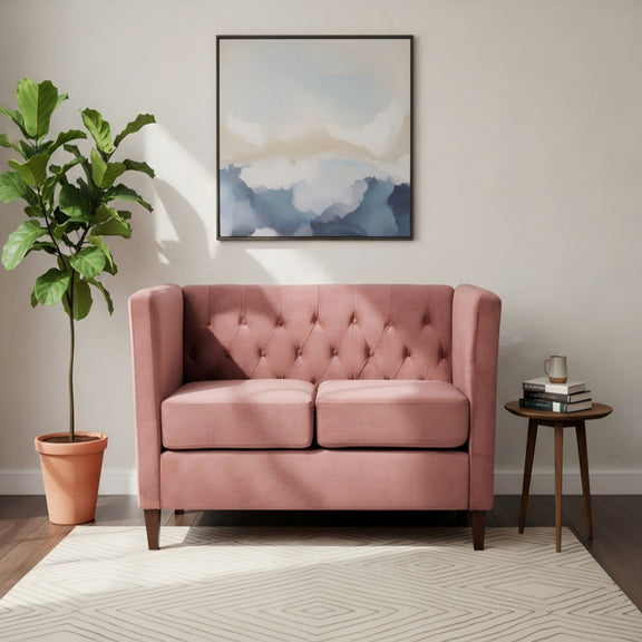 Pink button-tufted loveseat with square arms and padded backrest, two-seat design