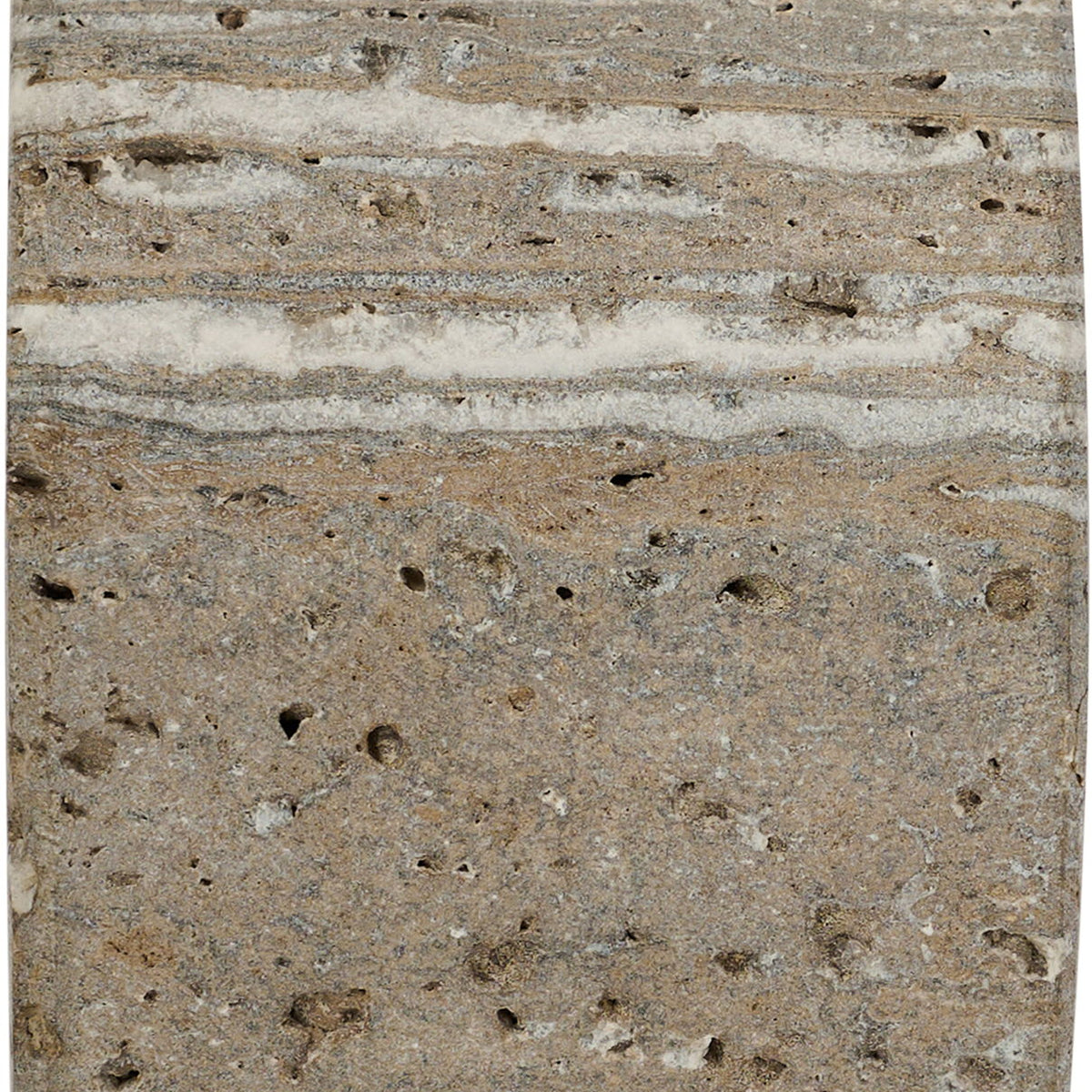 Travertine bookend close-up with speckled surface and natural horizontal striations