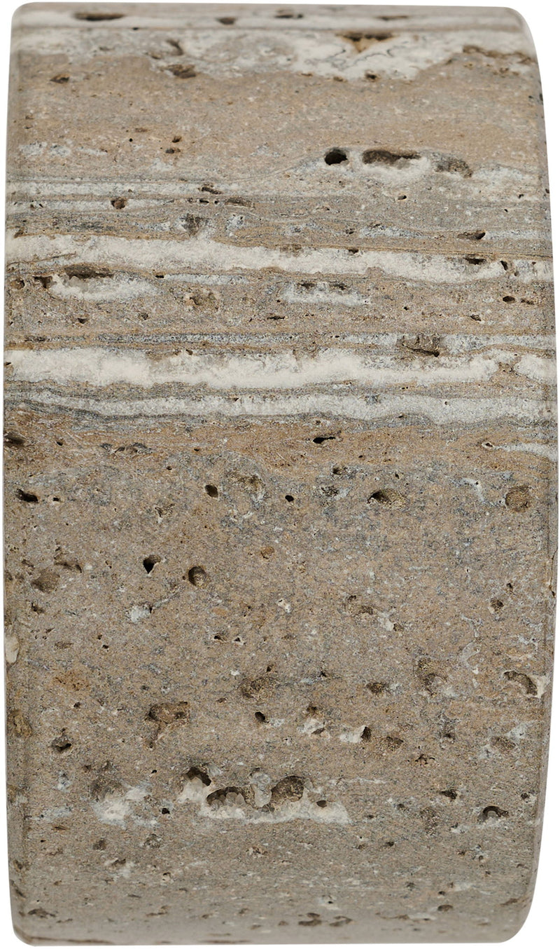 Travertine bookend close-up with speckled surface and natural horizontal striations
