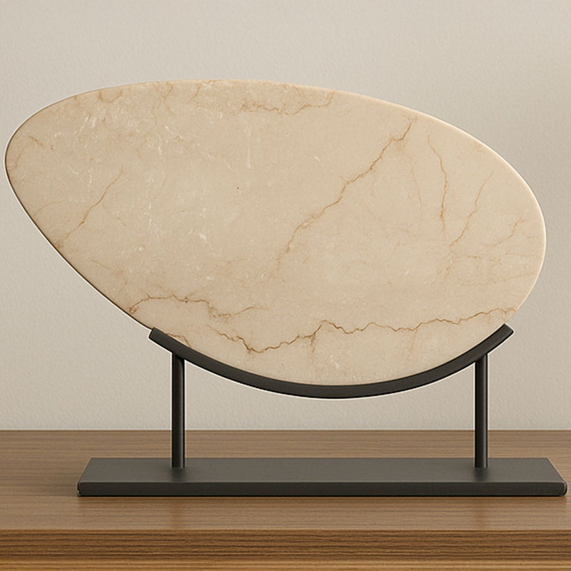 Beige oval stone sculpture with black metal frame on flat dark base