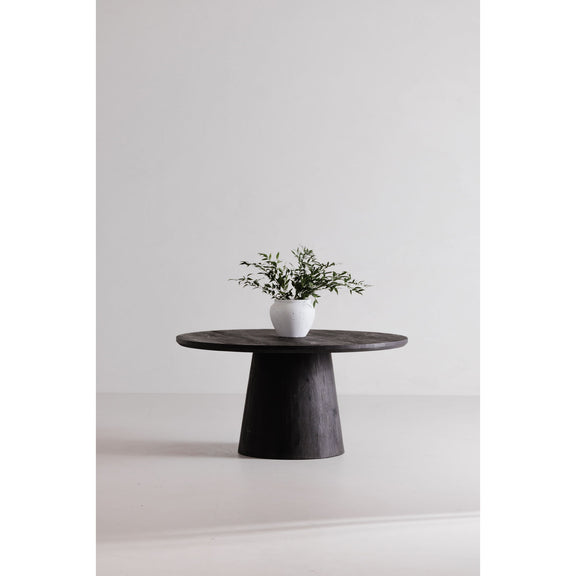 Cember round dining table with dark wood pedestal base and white planter