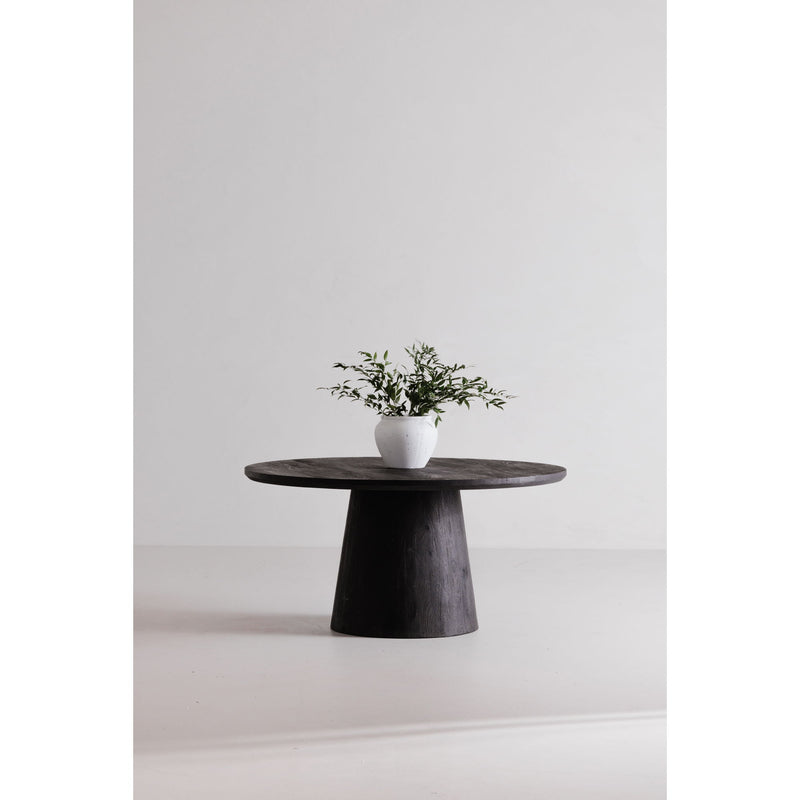 Cember round dining table with dark wood pedestal base and white planter