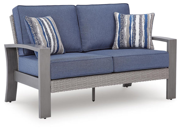 Blue cushioned gray-frame loveseat with two striped pillows, angled front view