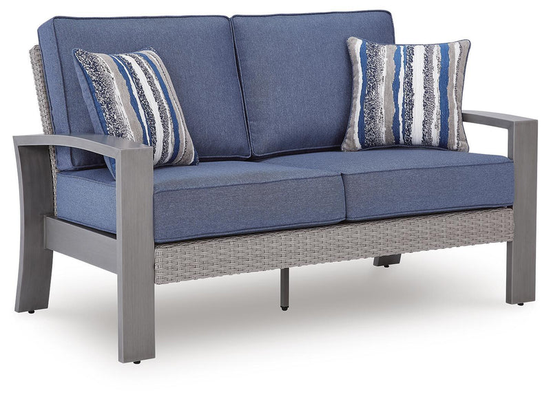Blue cushioned gray-frame loveseat with two striped pillows, angled front view