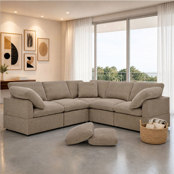 Camel corner sofa with deep seats and two loose pillows, arranged in an L shape.
