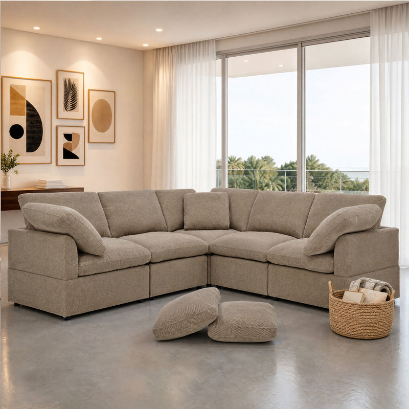 Camel corner sofa with deep seats and two loose pillows, arranged in an L shape.