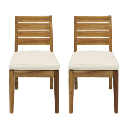 Light brown armless outdoor dining chair with white seat cushion and slatted back