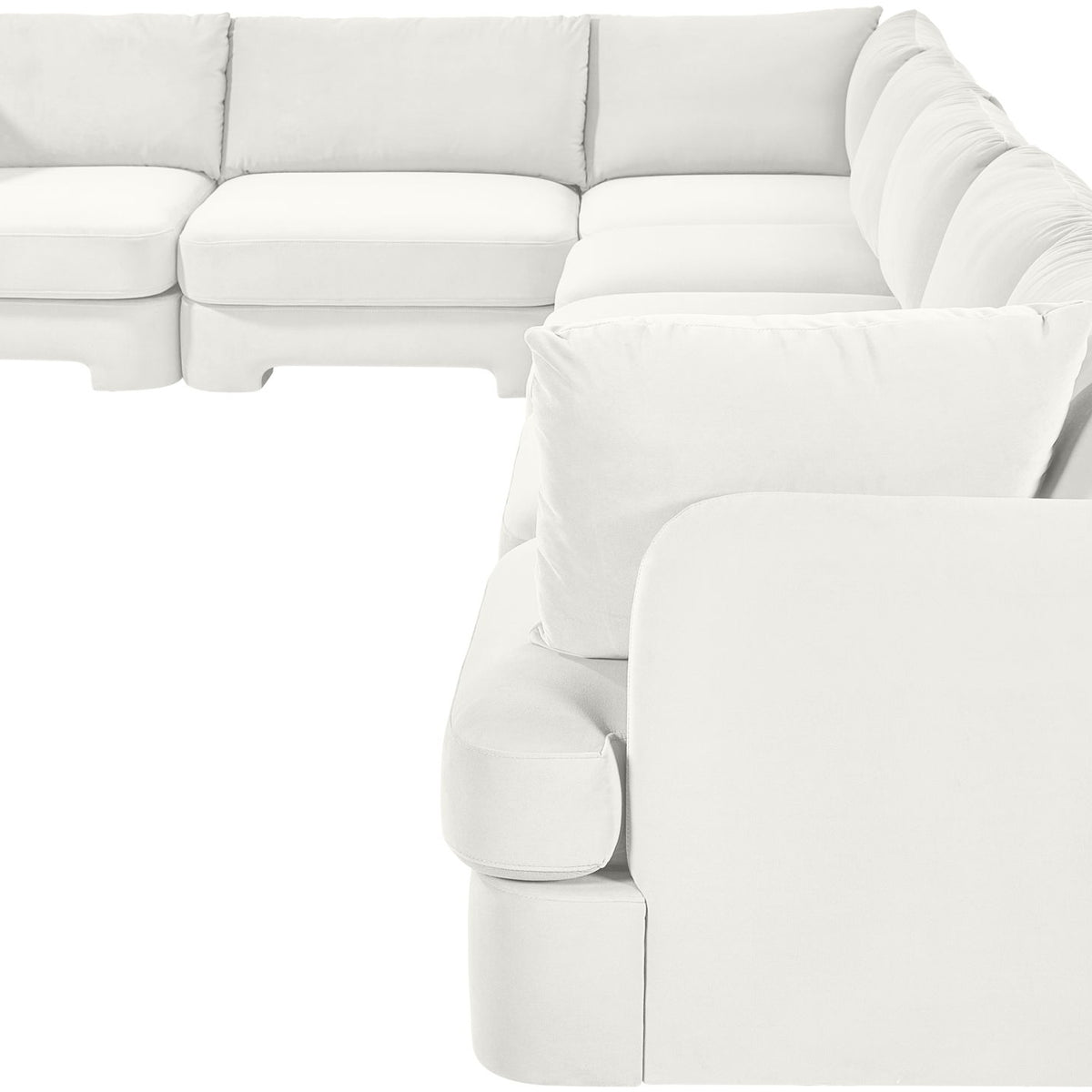 White velvet sectional sofa with rounded arm pads and plush seat cushions