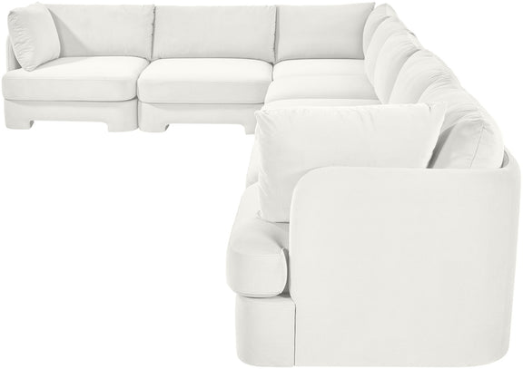 White velvet sectional sofa with rounded arm pads and plush seat cushions