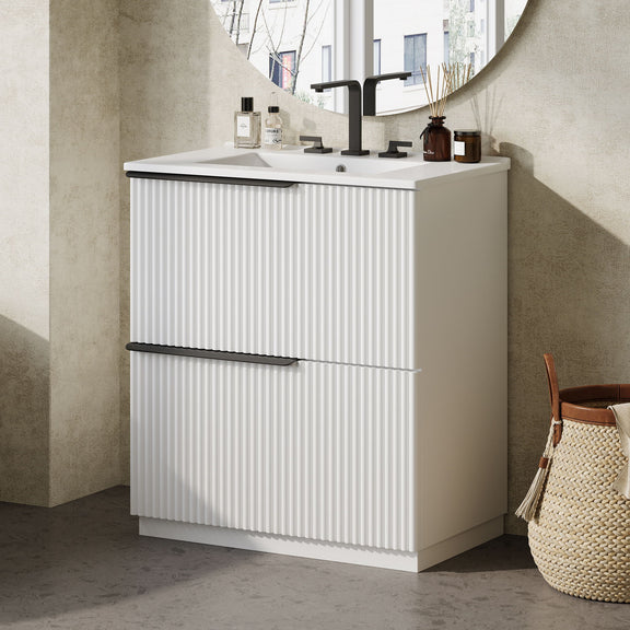 White fluted freestanding bathroom vanity with ceramic sink and bar handle