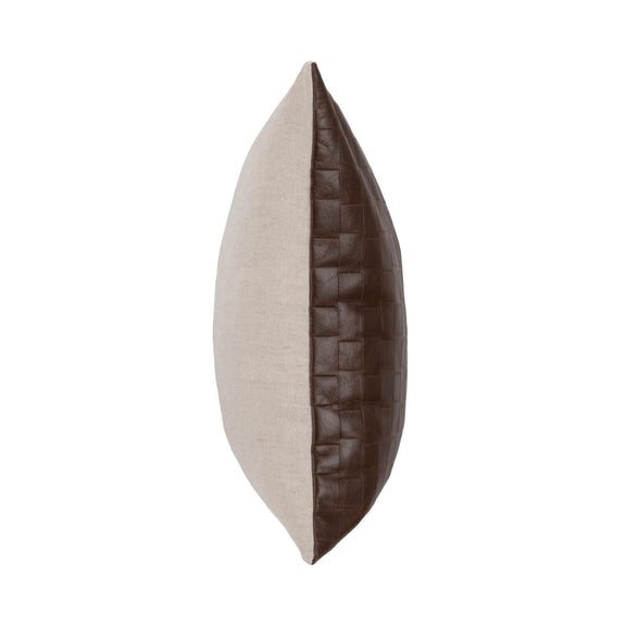 Brown leather pillow side view with quilted grid texture and stitched seam
