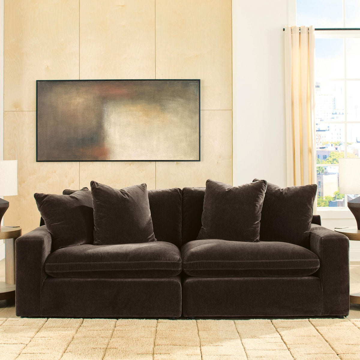 Dark brown 2-piece sectional sofa with four throw pillows and plush seat