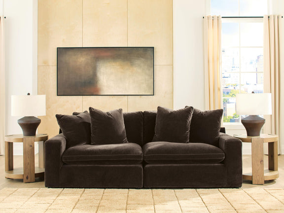 Dark brown 2-piece sectional sofa with four throw pillows and plush seat