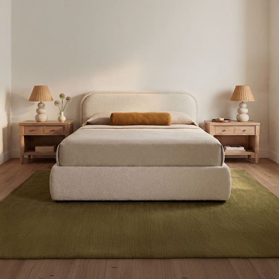Upholstered king storage bed in oatmeal with padded headboard and platform base