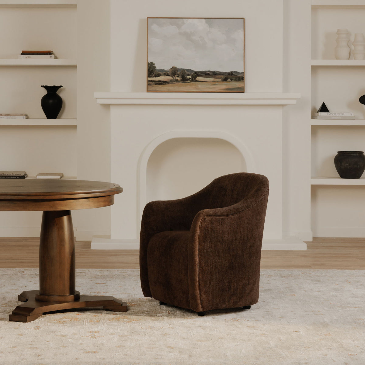 Dark brown upholstered rolling dining chair with curved back and caster base