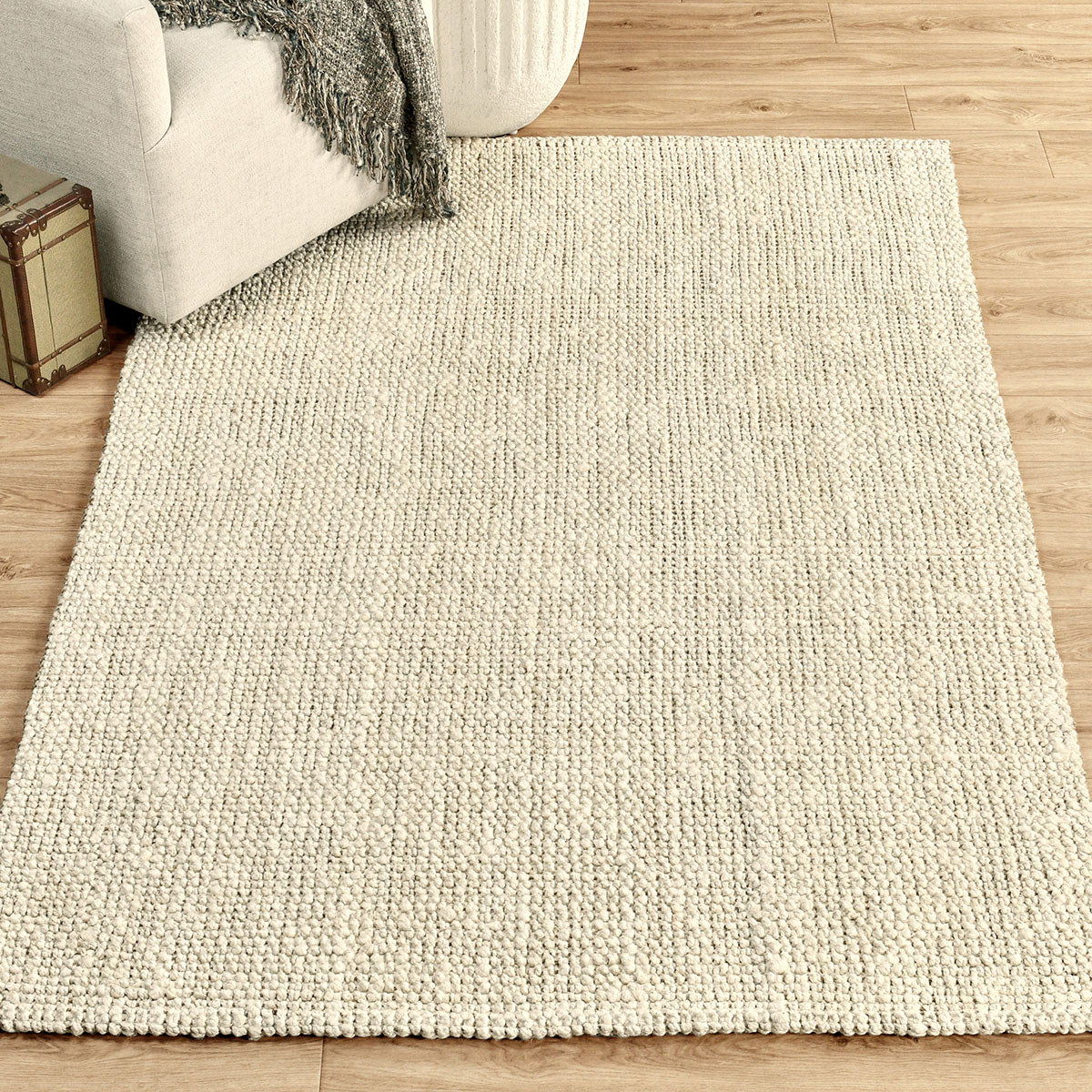 Light ivory chunky loop rug with dense textured pile, flat woven appearance