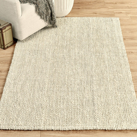 Light ivory chunky loop rug with dense textured pile, flat woven appearance