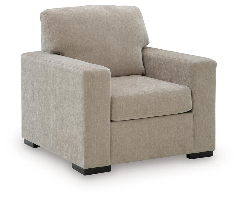 Light brown upholstered armchair with wide arms, curved back cushion, and dark rectangular legs.