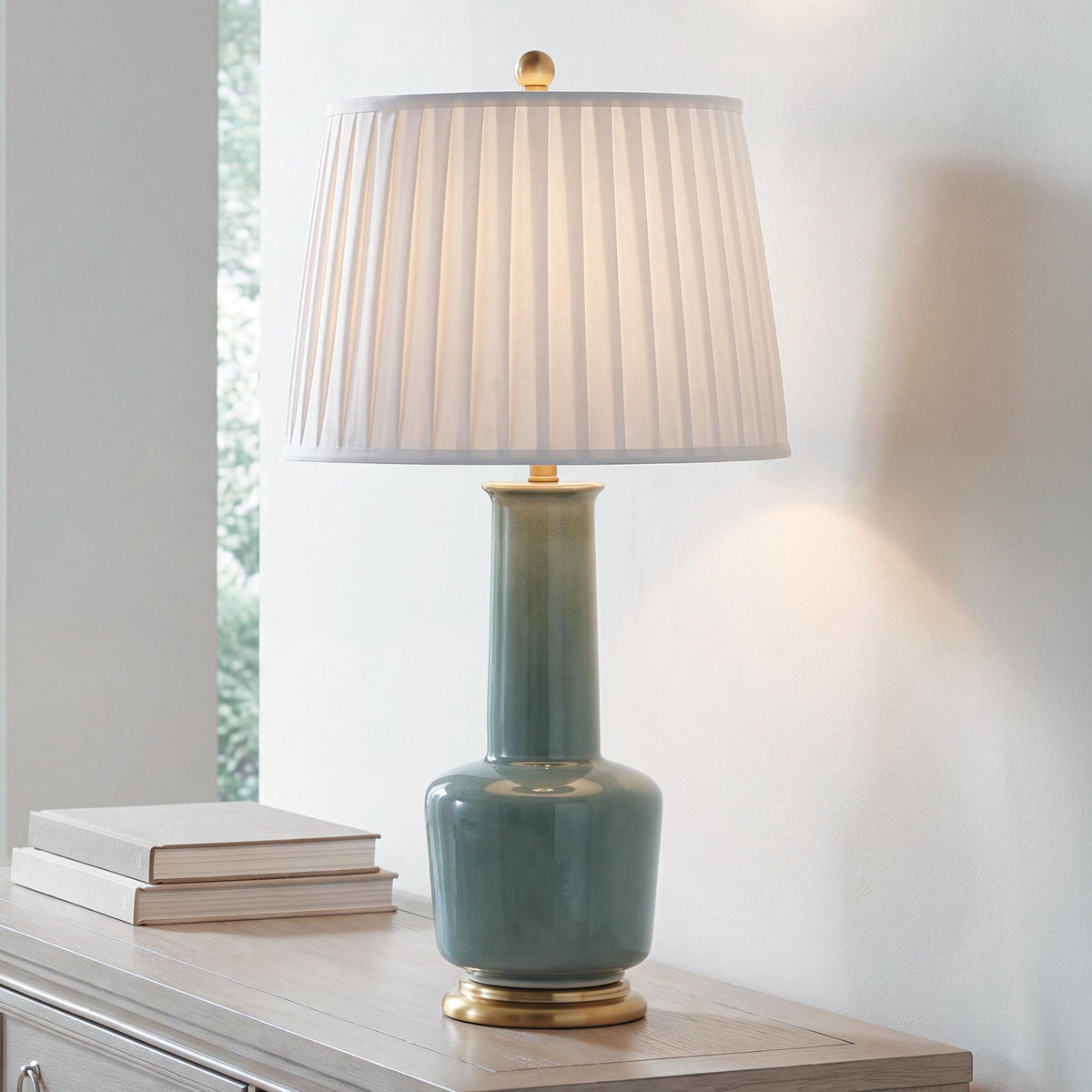 Teal ceramic table lamp with pleated white shade and gold base