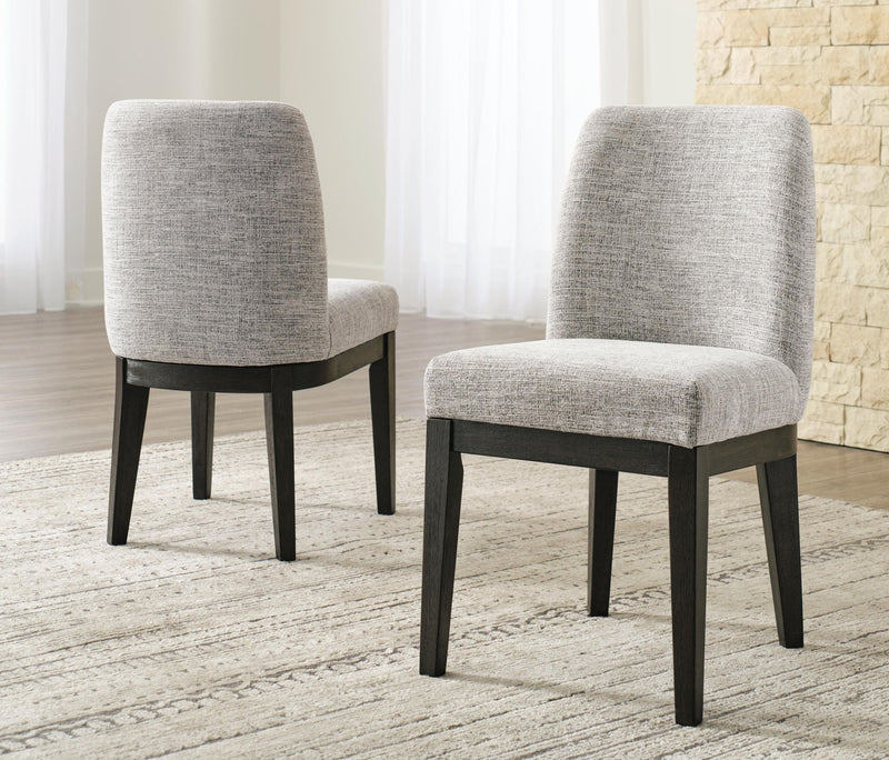Two beige upholstered dining side chairs with dark brown legs, front 3/4 view