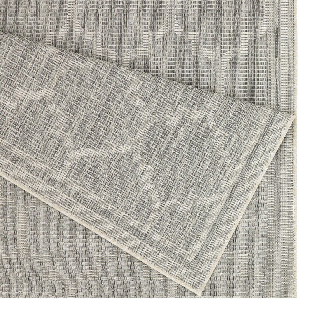 Light gray polypropylene area rug corner detail with quatrefoil motif