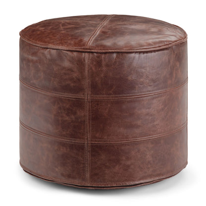 Round leather pouf in dark brown with stitched panel seams and domed top