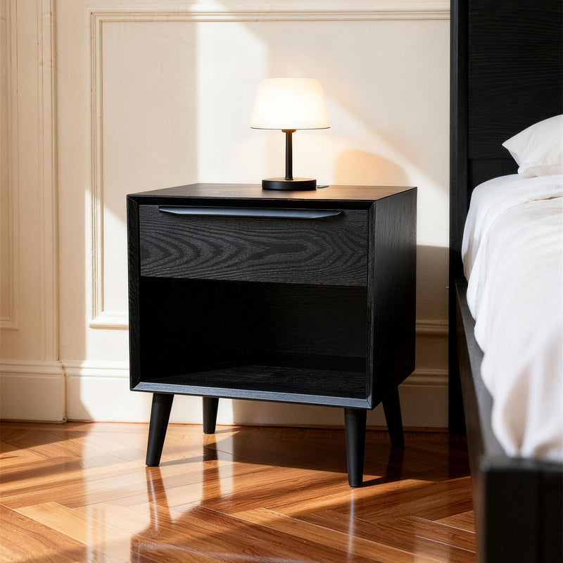 Black bedside table with 1 drawer and open shelf, top surface shown