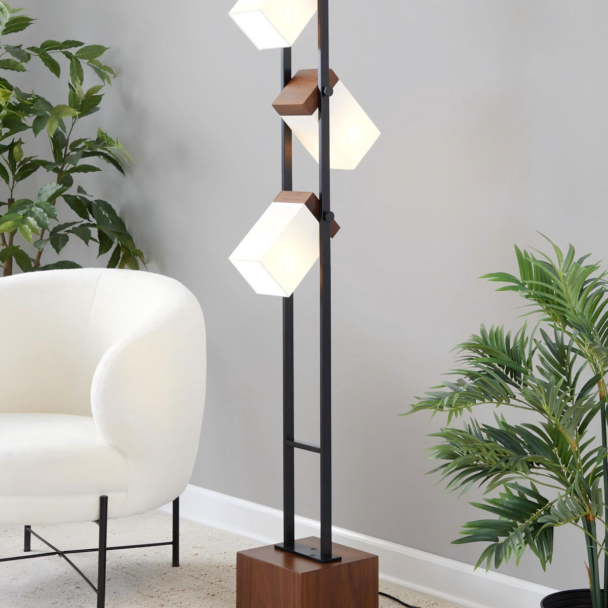 Black floor lamp with tiered white cube shades and walnut square base