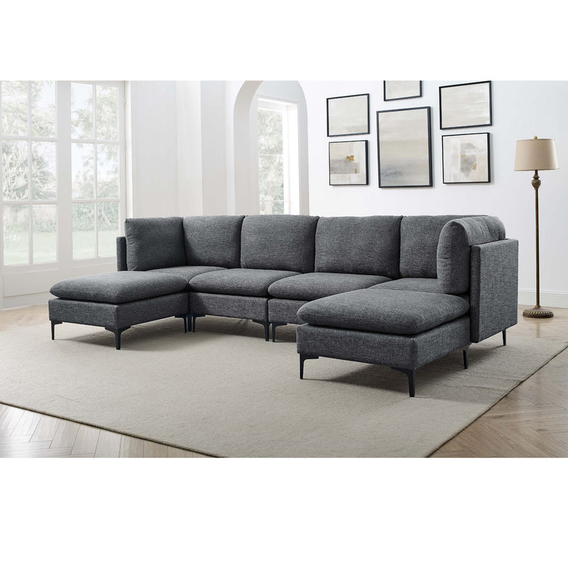 Modular sectional sofa with tall legs, upholstered in dark gray, with ottoman chaise