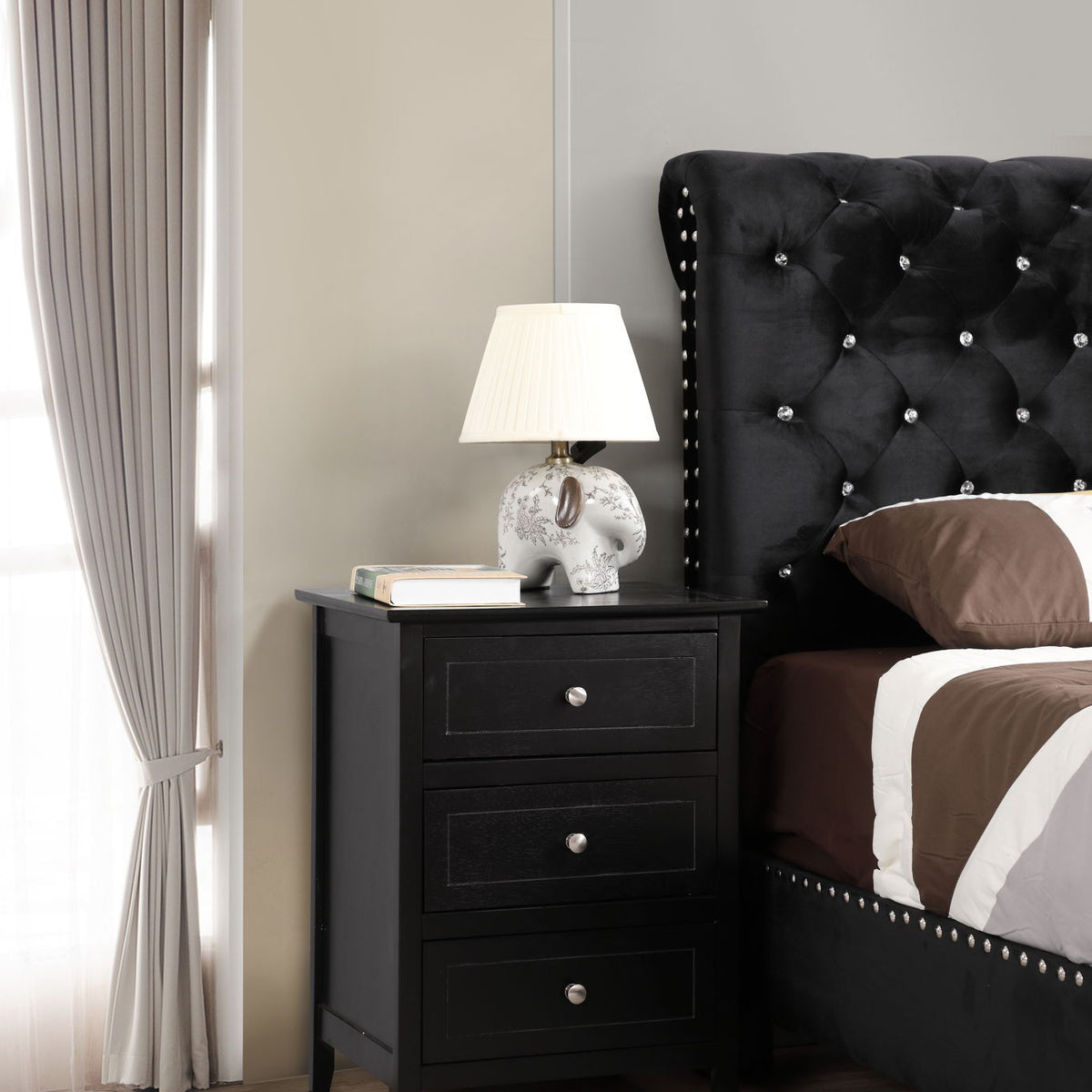 Black 3-drawer nightstand with three drawers and round metal knobs.