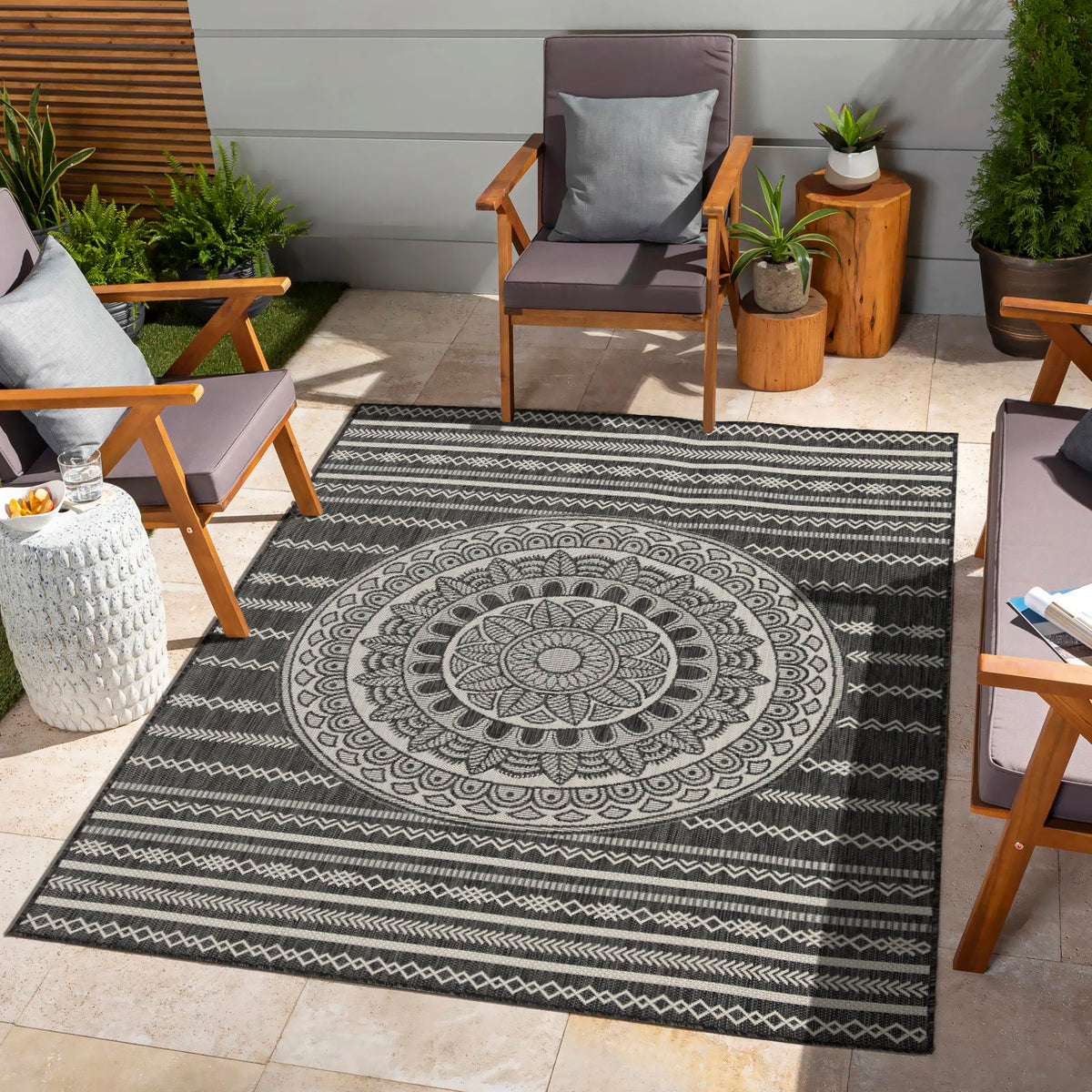 Indoor/outdoor area rug with navy and white mandala center and repeating zigzag border