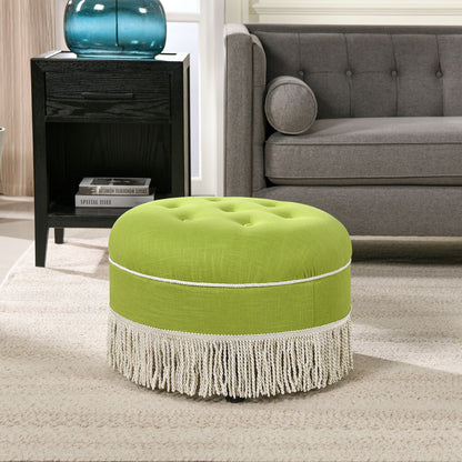 Round upholstered accent ottoman in lime green with white fringe trim and gold piping