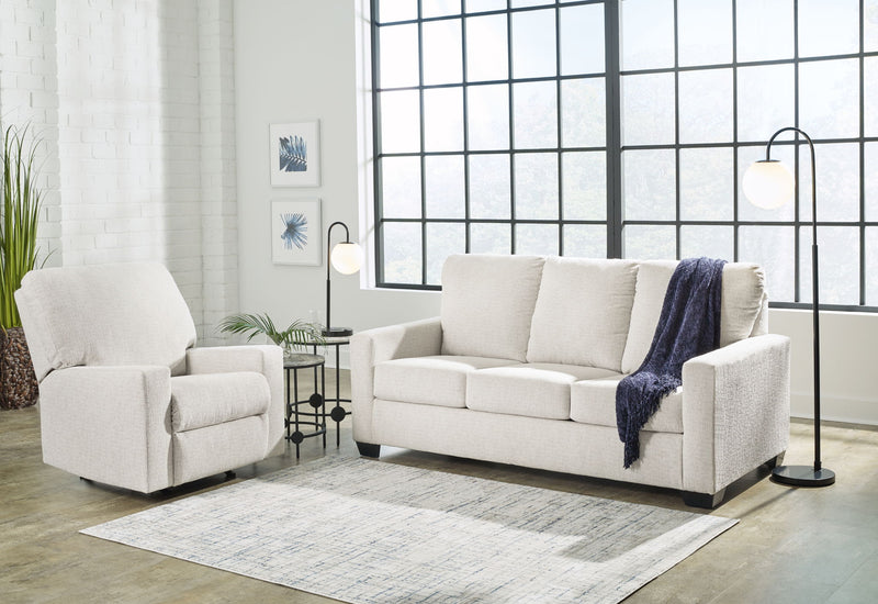 Beige fabric living room sofa with matching armchair, cushioned seats and rolled arms