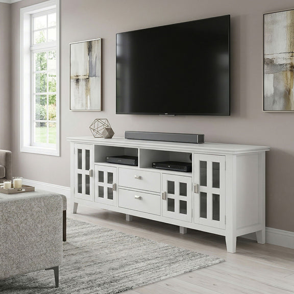 White TV media stand with center soundbar shelf and open storage behind glass doors