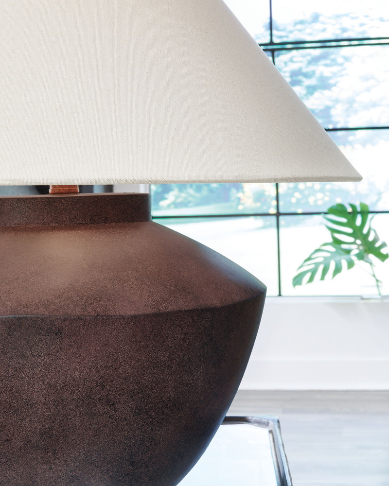 Antique brown poly table lamp with off-white shade, angled view of base