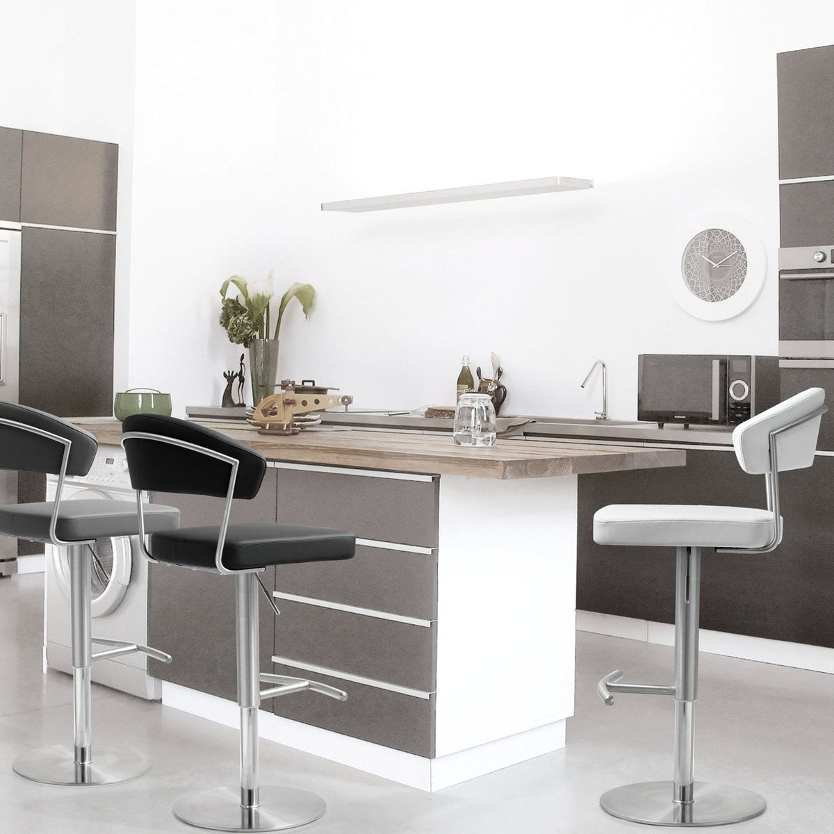 Stainless steel barstools with cushioned seats in a kitchen setting (multiple stools shown).