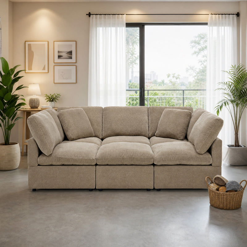 Front view of a light brown three-seat sofa with plush loose cushions