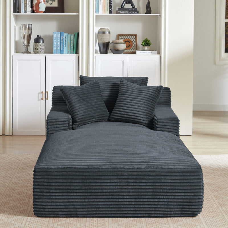 Dark gray chaise lounge viewed from the front, with ribbed upholstery and three cushions