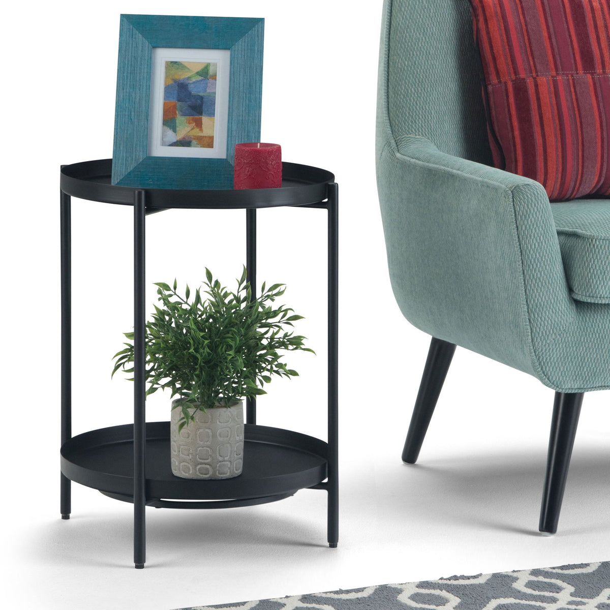 Black round two-tier metal table with lower shelf holding a plant pot