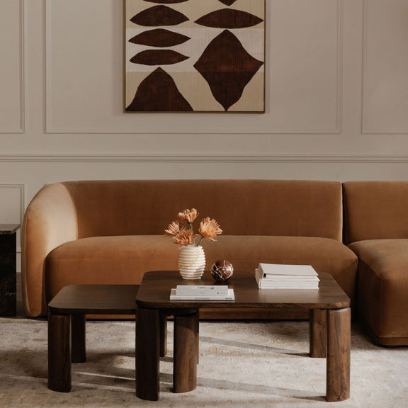 Framed abstract painting with beige background and dark brown geometric leaf shapes